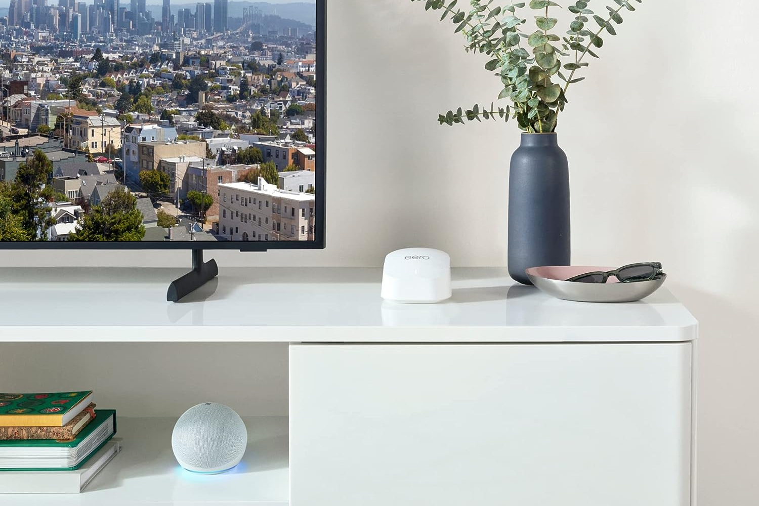 A single Amazon Eero 6+ Mesh Wi-Fi unit sitting on a TV stand.